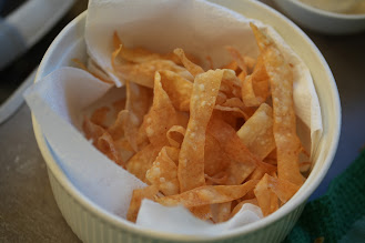 Crisp fried strips of leftover samosa pastry in a small ramekin